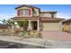 Beautiful two-story home featuring a red tile roof, desert landscaping, and a two-car garage at 19426 W San Juan Ave, Litchfield Park, AZ 85340