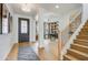 Inviting foyer with wood floors, staircase, and open view to an office, creating a seamless transition at 19426 W San Juan Ave, Litchfield Park, AZ 85340