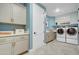 Well-organized laundry room with modern appliances, ample cabinetry, and stylish decor at 19426 W San Juan Ave, Litchfield Park, AZ 85340