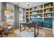 Stylish office featuring custom shelving, a modern desk, and comfortable seating area at 19426 W San Juan Ave, Litchfield Park, AZ 85340