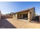 Spacious backyard featuring a covered patio with sliding glass doors and block wall fencing, ideal for outdoor living at 20073 S 231St Pl, Queen Creek, AZ 85142