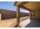 A large covered patio area with ample space and block wall fencing in a spacious dirt backyard at 20073 S 231St Pl, Queen Creek, AZ 85142