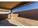 Open patio with a view of the backyard featuring a block wall and minimal landscaping, perfect for customization at 20073 S 231St Pl, Queen Creek, AZ 85142