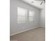 Neutral toned bedroom featuring carpet, a ceiling fan, and two windows at 20073 S 231St Pl, Queen Creek, AZ 85142