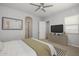 Bedroom featuring a ceiling fan, closet access, and a comfortably furnished bed at 20073 S 231St Pl, Queen Creek, AZ 85142