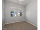Bedroom featuring carpeted floors, two windows providing natural light, and neutral colored walls at 20073 S 231St Pl, Queen Creek, AZ 85142
