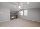 Spacious bonus room with vaulted ceiling, fan, and two large windows providing natural light at 20073 S 231St Pl, Queen Creek, AZ 85142