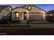Exterior view of a cozy home with a beautiful entrance and a well-lit driveway at 20073 S 231St Pl, Queen Creek, AZ 85142