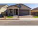 Charming single-story home with a well-manicured lawn and a two-car garage at 20073 S 231St Pl, Queen Creek, AZ 85142