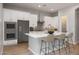Modern kitchen with white cabinets, stainless steel appliances, and center island with bar seating at 20073 S 231St Pl, Queen Creek, AZ 85142
