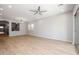 Spacious living room with wood-style flooring, recessed lighting, and access to the backyard at 20073 S 231St Pl, Queen Creek, AZ 85142