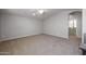 Spacious living room with carpet, neutral walls, and open doorway at 20073 S 231St Pl, Queen Creek, AZ 85142