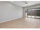 Living room with wood-look floors and sliding glass doors to the backyard at 20073 S 231St Pl, Queen Creek, AZ 85142