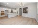 Large open space with light wood floors and a view into the kitchen at 20073 S 231St Pl, Queen Creek, AZ 85142