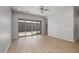 Open living room with sliding glass doors, hardwood floors, and neutral paint at 20073 S 231St Pl, Queen Creek, AZ 85142
