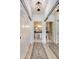 Bright bathroom entrance with decorative rug and bead chandelier at 20100 N 78Th Pl # 1048, Scottsdale, AZ 85255