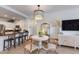 Cozy dining area with modern chandelier and ample natural light spilling in through the window at 20100 N 78Th Pl # 1048, Scottsdale, AZ 85255