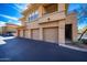 View of multiple attached garages featuring a stairwell and second-story balcony access at 20100 N 78Th Pl # 1048, Scottsdale, AZ 85255