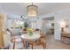 Bright living room featuring a modern chandelier, dining area, and expansive windows at 20100 N 78Th Pl # 1048, Scottsdale, AZ 85255