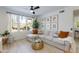 Bright living room with large windows, a comfortable sectional, and a round coffee table at 20100 N 78Th Pl # 1048, Scottsdale, AZ 85255