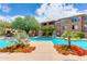 Stunning pool area surrounded by lush landscaping, lounge chairs, and a view of the multi-story building at 20100 N 78Th Pl # 1048, Scottsdale, AZ 85255