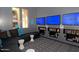 A modern recreation room featuring a comfortable sectional sofa and multiple large screen televisions at 20100 N 78Th Pl # 1048, Scottsdale, AZ 85255