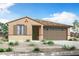 Charming single-story home with a tile roof, stucco siding, desert landscaping and a two-car garage at 24191 W Agora Ln, Buckeye, AZ 85326