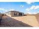 Large backyard space with freshly laid dirt, ready for landscaping, and a tall block fence for privacy at 24791 N 169Th Dr, Surprise, AZ 85387