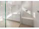 Bright and airy bathroom featuring dual vanities, a large mirror, and a walk-in shower with sleek tile design at 24791 N 169Th Dr, Surprise, AZ 85387