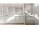 Bright bathroom featuring dual sinks, white cabinetry, and a frameless walk-in shower with modern fixtures at 24791 N 169Th Dr, Surprise, AZ 85387