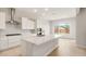 Modern white kitchen with a center island and stainless steel appliances at 24791 N 169Th Dr, Surprise, AZ 85387