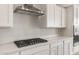Modern kitchen featuring stainless steel range hood and quartz countertops at 24791 N 169Th Dr, Surprise, AZ 85387