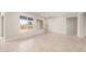 Well-lit living room with tile floors and view of the backyard at 24791 N 169Th Dr, Surprise, AZ 85387