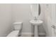 This well-lit powder room includes a pedestal sink, oval mirror, and toilet creating a functional space at 24791 N 169Th Dr, Surprise, AZ 85387