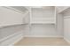 Spacious walk-in closet with multiple shelves and rods for optimal organization and storage space at 24791 N 169Th Dr, Surprise, AZ 85387