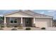 Charming single-story home featuring stone accents, neutral colors, and a two-car garage at 32101 N Lone Rancher Way, San Tan Valley, AZ 85140