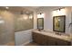 Modern bathroom with a double sink vanity, granite countertop, and glass shower at 32541 N 135Th Dr, Peoria, AZ 85383