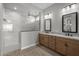 Modern bathroom featuring double vanity and spacious walk-in shower with tile surround at 32541 N 135Th Dr, Peoria, AZ 85383