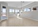 Bright dining room with large windows, tile flooring, and stylish chandelier at 32541 N 135Th Dr, Peoria, AZ 85383