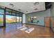 Exercise room featuring large windows, mats, and a mirror for workouts with open door to outdoors at 32541 N 135Th Dr, Peoria, AZ 85383