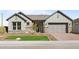 Charming single-Gathering home with stone accents, manicured front yard, and two-car garage at 32541 N 135Th Dr, Peoria, AZ 85383