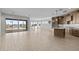 Open-concept kitchen and living area with tile floors, granite countertops, and stainless steel appliances at 32541 N 135Th Dr, Peoria, AZ 85383