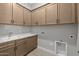 Functional laundry room with sink and ample storage at 32541 N 135Th Dr, Peoria, AZ 85383