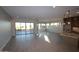 Bright living room with tiled floor, multiple windows allowing natural light and a sliding door to backyard at 32541 N 135Th Dr, Peoria, AZ 85383
