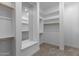 Walk-in closet with custom shelving, ample storage space, and built-in mirror at 32541 N 135Th Dr, Peoria, AZ 85383