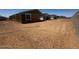 Exterior shot of a new home construction site, featuring exposed frame, and gravel yard at 32637 N Newby Dr, San Tan Valley, AZ 85143