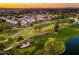 Panoramic aerial view of a golf course community, highlighting lush greenery and tranquil water features at 3665 S Jojoba Way, Chandler, AZ 85248