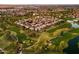 Aerial view of a community situated on a golf course, showcasing the beautiful landscaping and residential homes at 3665 S Jojoba Way, Chandler, AZ 85248