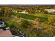 Aerial view of a house on a golf course with lush landscaping and a pool in a serene neighborhood at 3665 S Jojoba Way, Chandler, AZ 85248