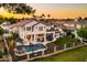 Aerial view featuring a pristine pool, lush backyard, and elegant two-story home at dusk at 3665 S Jojoba Way, Chandler, AZ 85248